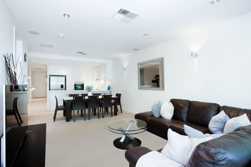A light-filled space to relax after a day by the coast, with comfortable seating and an easy connection to the dining and kitchen areas.