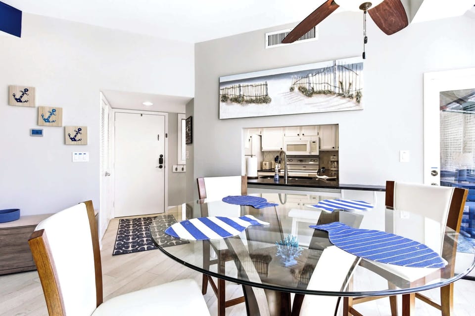 Glass table for four, nautical accents, and that easy beach-house feel throughout.