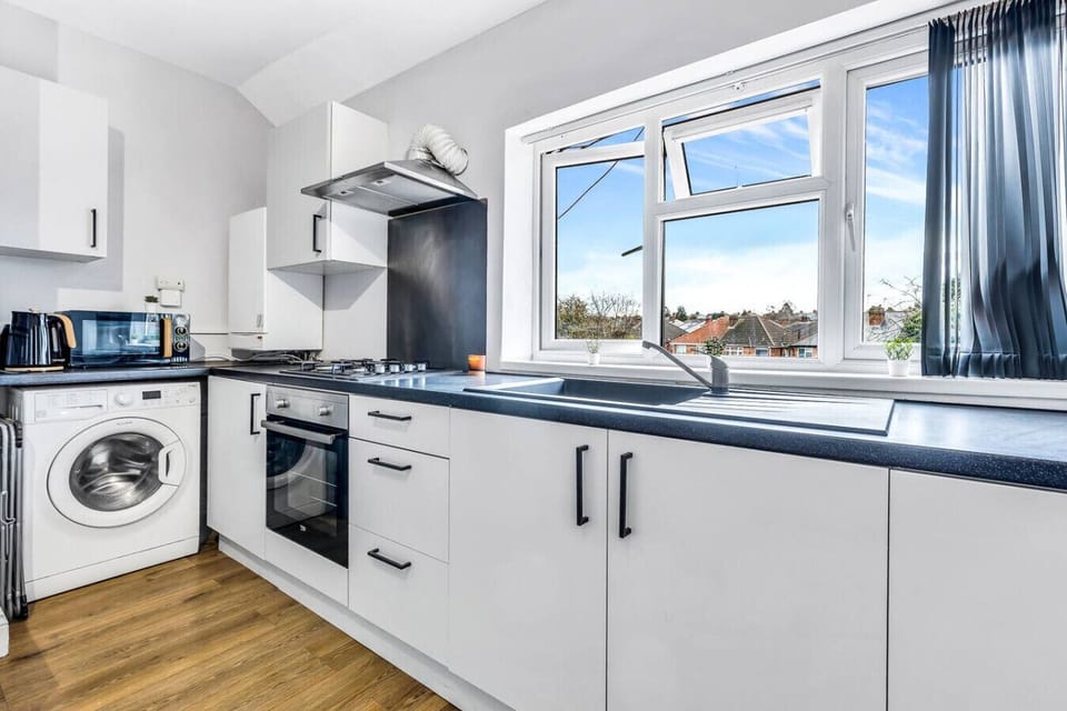 Fully equipped kitchen with washing machine, kettle, toaster, and Hive heating control.