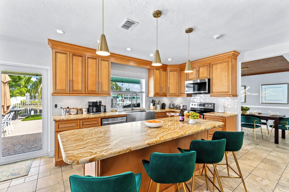 Kitchen detail showing breakfast bar seating and prep space.
