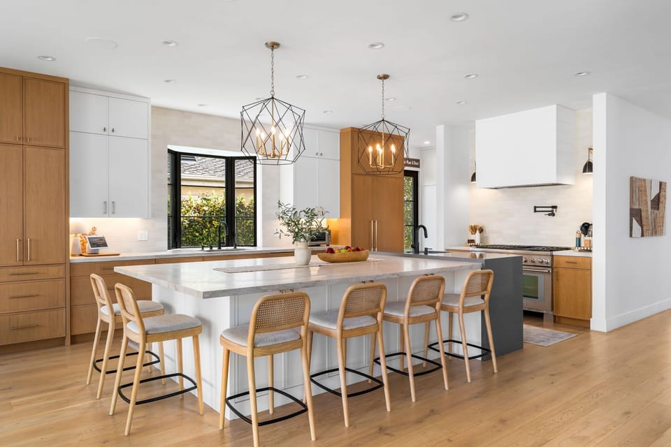 A bright kitchen with a central island, with bar seating designed for gathering and creating memories