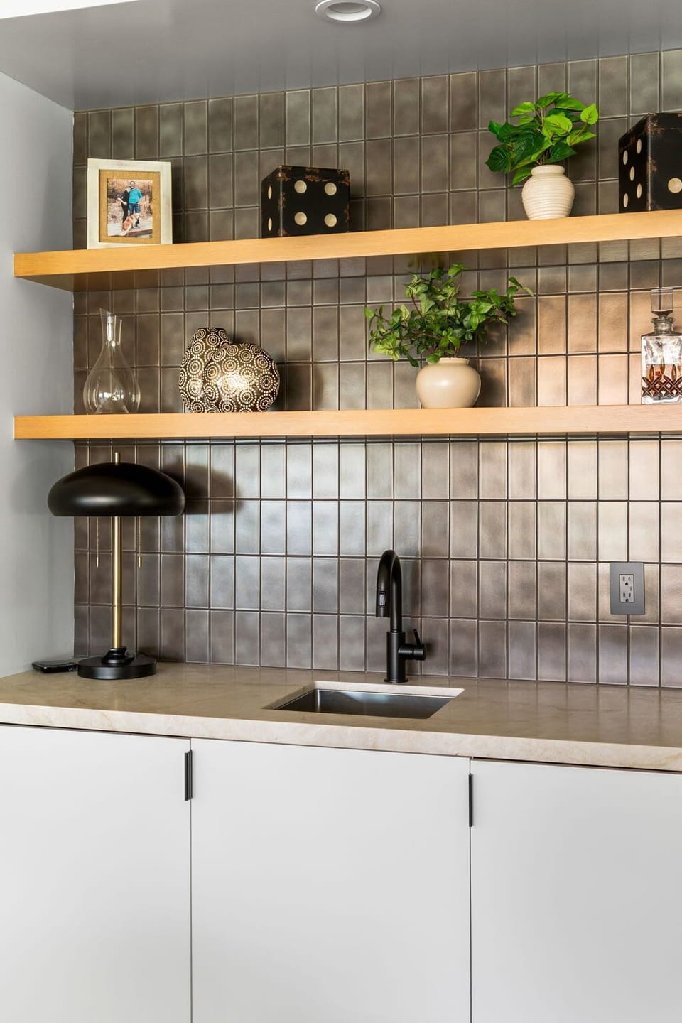 A well-appointed wet bar with open shelving, clean finishes, and a streamlined setup for easy use.