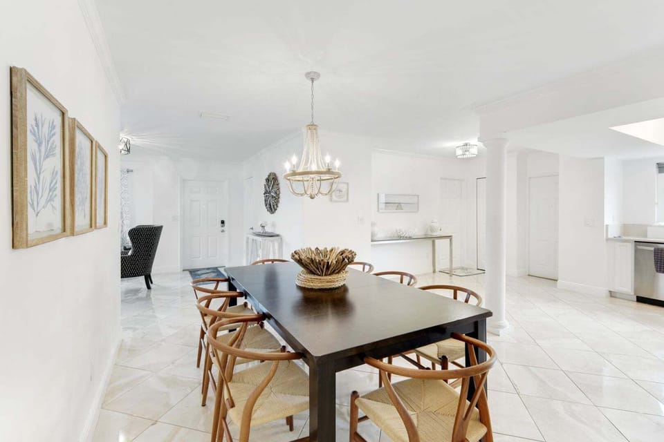 Elegant dining area with a spacious table, stylish lighting, and an open layout—perfect for meals and gathering together.