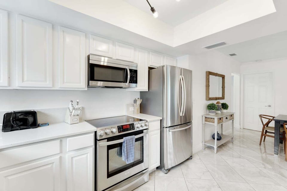 Modern kitchen with stainless steel appliances, ample counter space, and everything you need for easy meal prep during your stay.