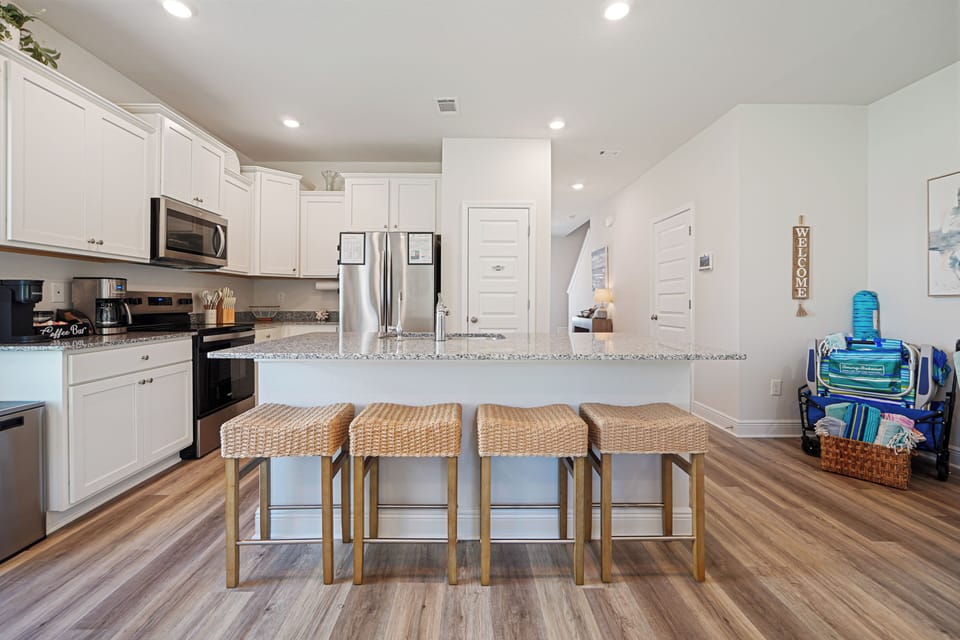Your spacious kitchen features granite countertops, stainless appliances, and a breakfast bar where you'll enjoy morning coffee together.
