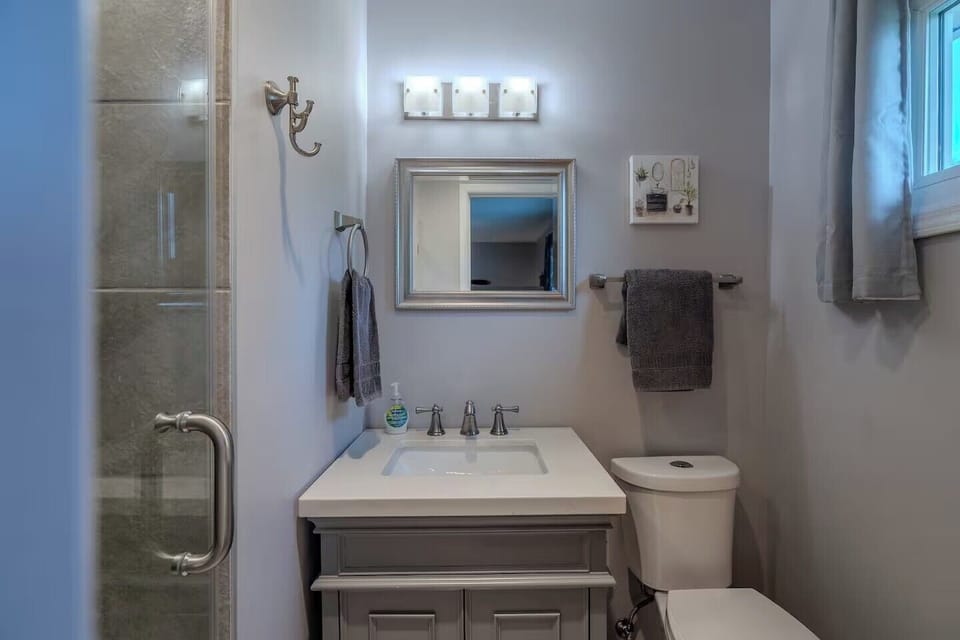 Step into your pristine bathroom featuring modern fixtures, fresh towels, and a spacious glass shower—your personal sanctuary awaits.