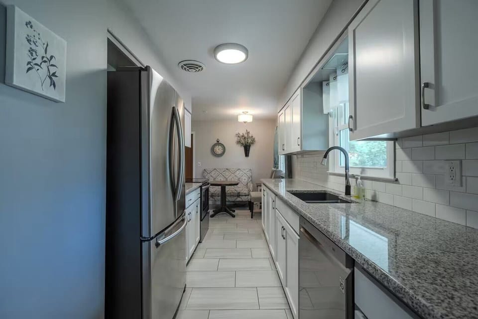 Your modern galley kitchen features granite countertops, stainless appliances, and subway tile backsplash for effortless meal prep.
