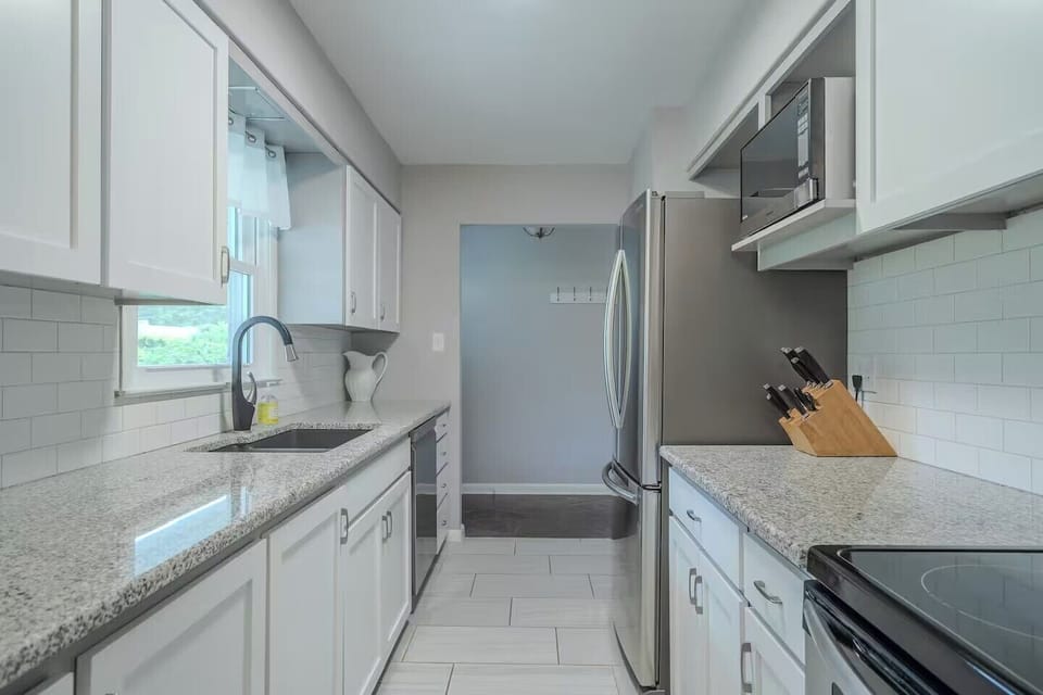 Your fully equipped galley kitchen sparkles with granite countertops, stainless steel appliances, and crisp white cabinetry—perfect for preparing memorable meals.