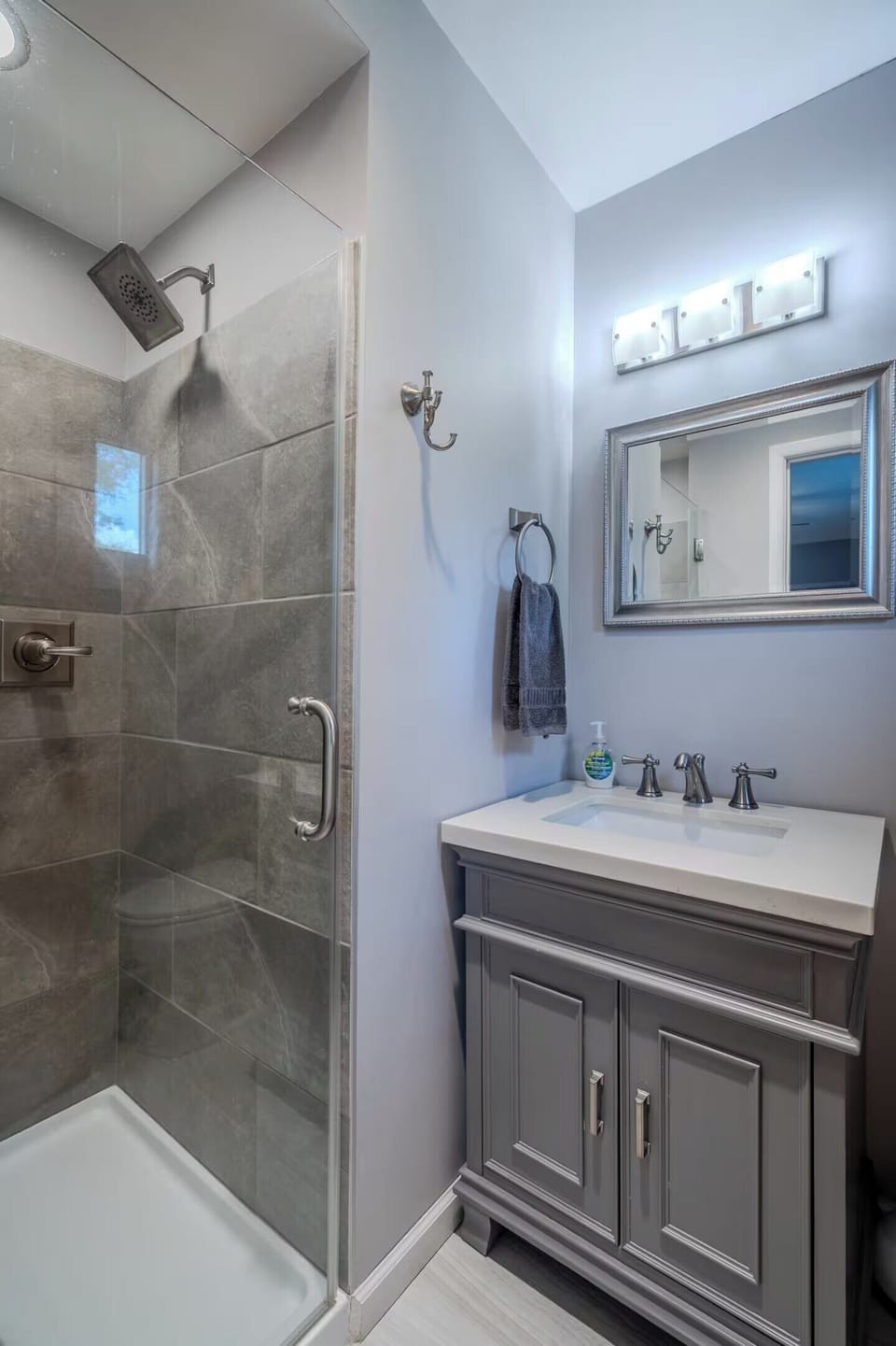 Step into your private sanctuary with a spacious glass shower and elegant vanity, perfect for your morning routine.