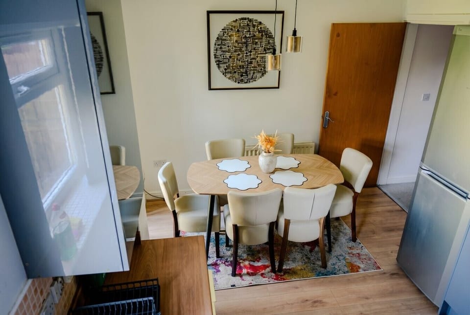 Dining area with a herringbone table, pendant lighting, and room for everyone.