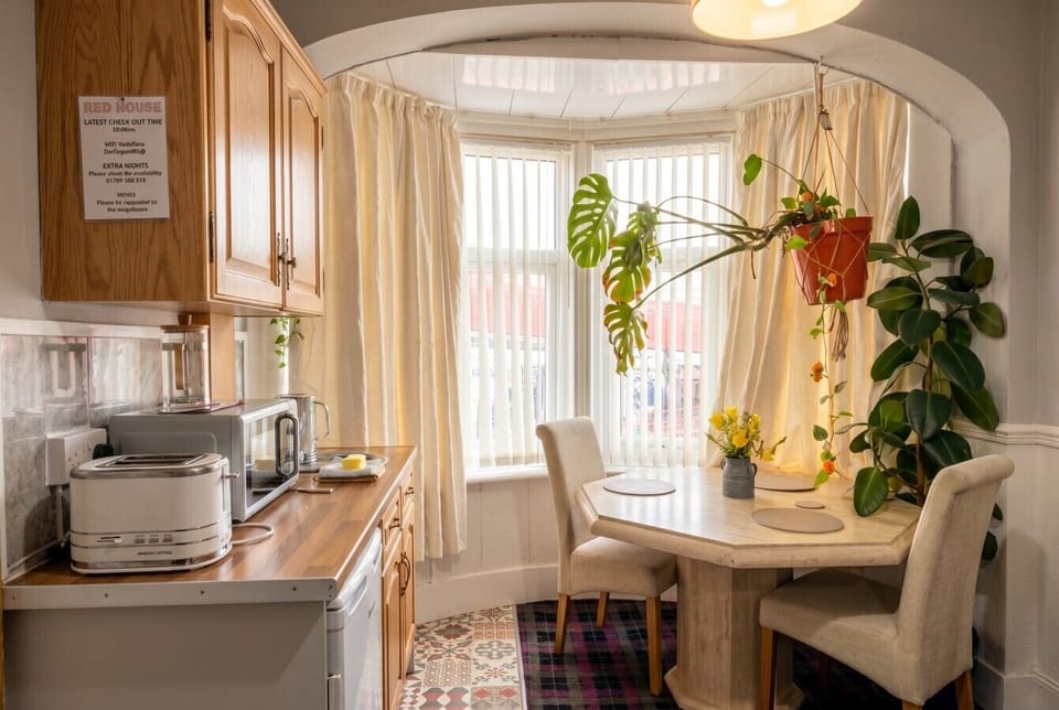 Cook and dine in a bright kitchen with a leafy bay window breakfast table.