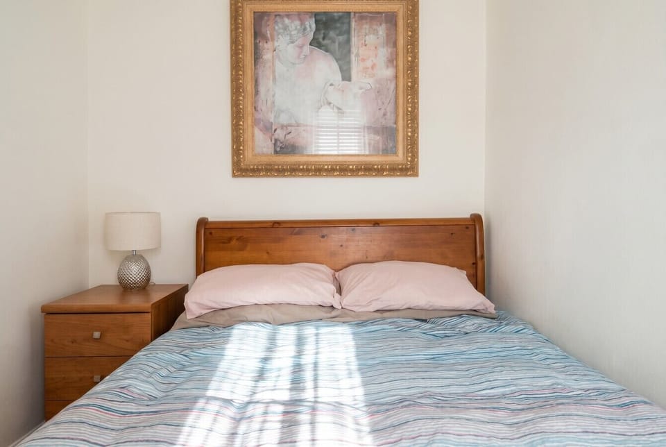 Wake up rested in a peaceful double bedroom with warm timber furnishings.