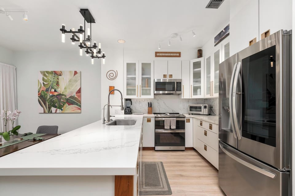 Your gourmet kitchen features marble counters, stainless steel appliances, and modern lighting - perfect for cooking memorable meals together.