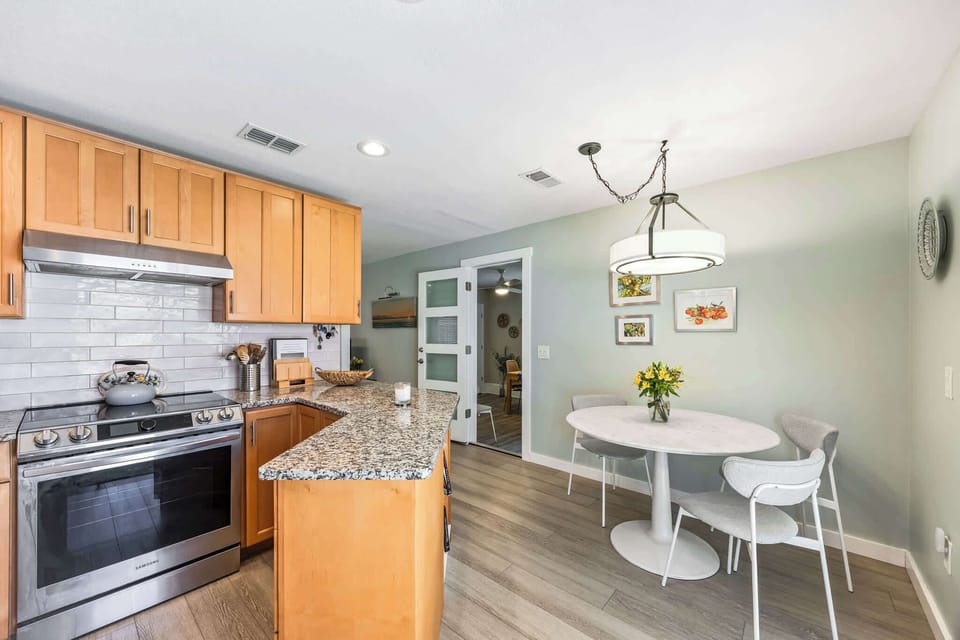 Modern kitchen with granite countertops and a cozy dining area