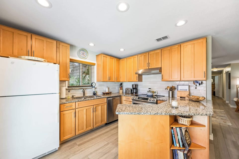Modern kitchen with granite countertops and ample wooden cabinetry