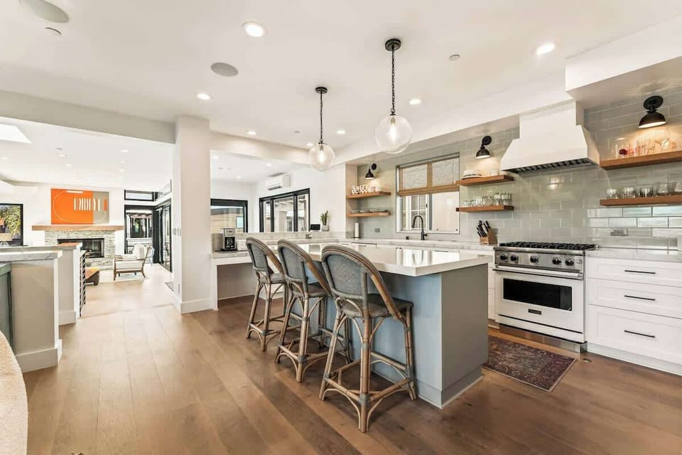 Bright and spacious kitchen with a generous island, bar seating, and an open layout designed for gathering and cooking together.