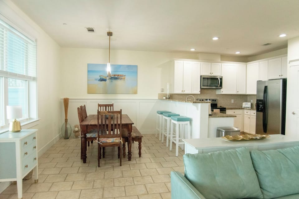 Large dining room table and countertop seating with Gulf views