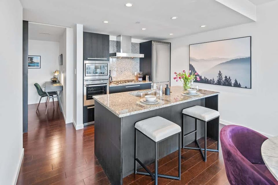 Unleash your inner chef in this fully equipped chef's kitchen, featuring gorgeous granite countertops and high-end stainless steel appliances.
