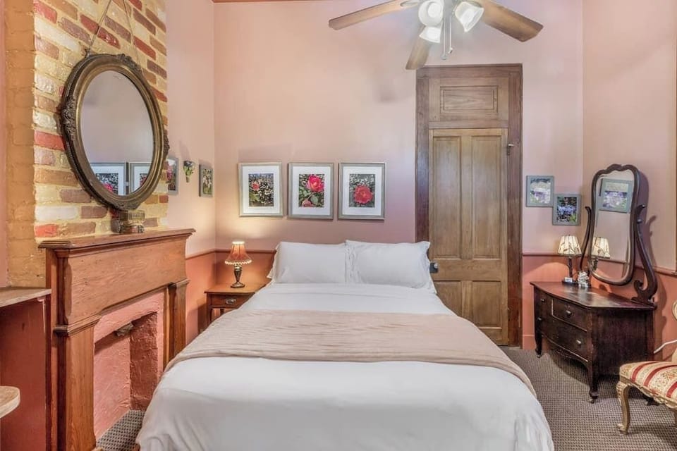 Charming bedroom with exposed brick, vintage accents, and a warm, inviting atmosphere.