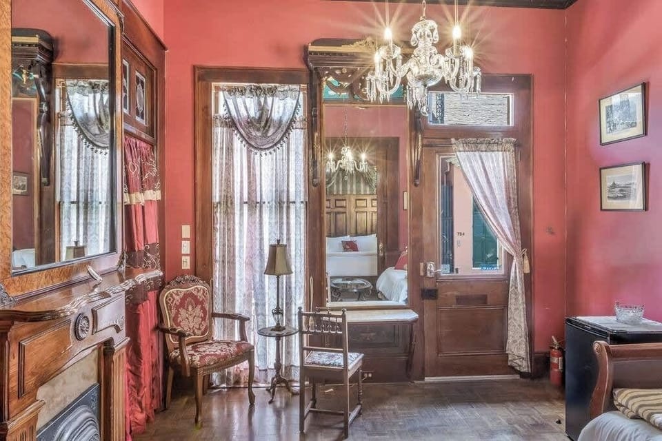 Beautiful sitting area with vintage decor, chandeliers, and a warm, inviting atmosphere.