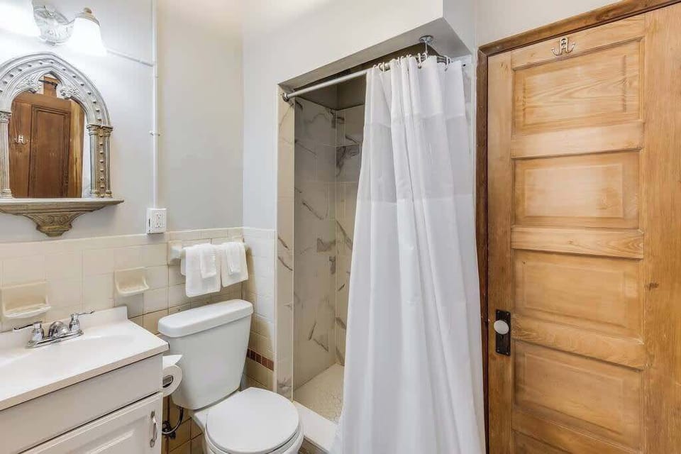 Full bathroom with vanity and tub/shower combo, offering a clean and functional setup.