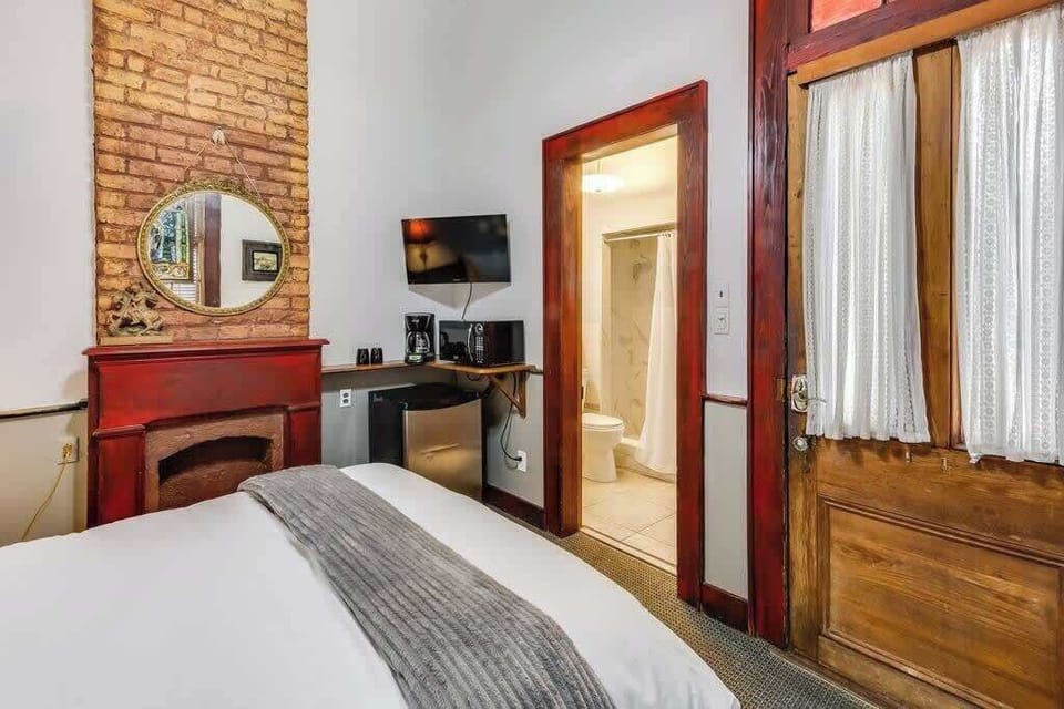 Bedroom with exposed brick accents and rich wood details, adding warmth and character.