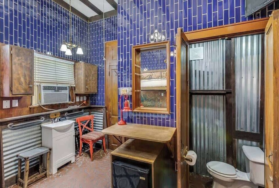 Bathroom area with striking tile design, vanity, and a functional layout for everyday convenience.