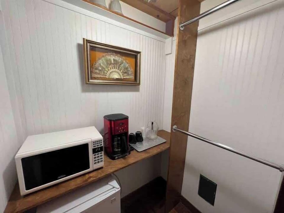 Compact kitchenette area with essentials for light meals, snacks, and added convenience.