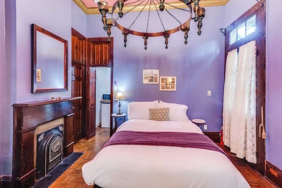 Charming bedroom with rich colors, vintage details, and a cozy, character-filled atmosphere.