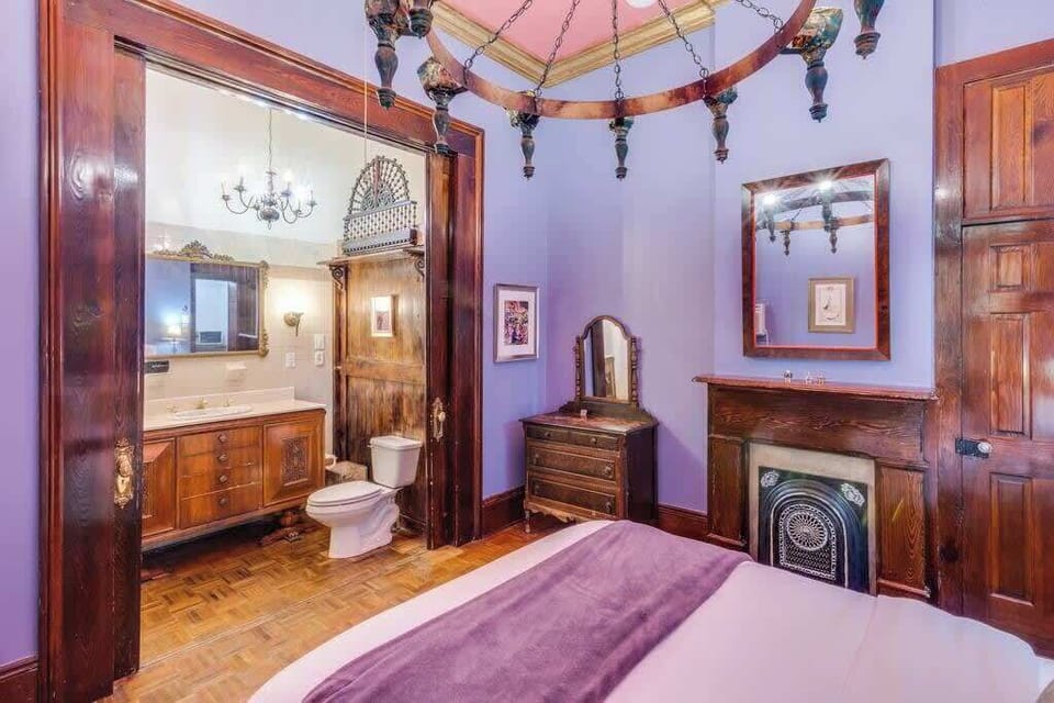 Bedroom and bathroom combination view showcasing the suite-style layout and elegant finishes.