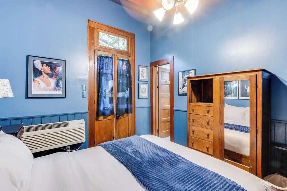 Another angle of the bedroom highlighting ample storage, natural light, and a clean, inviting layout.