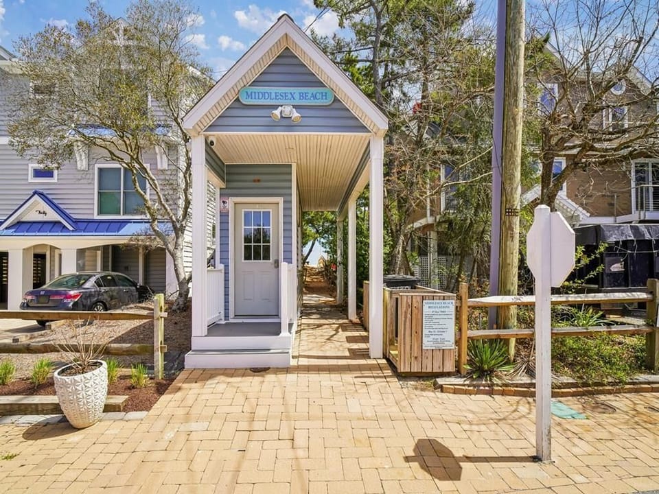 Covered entry area and front facade of the house — the beach is less than a block away
