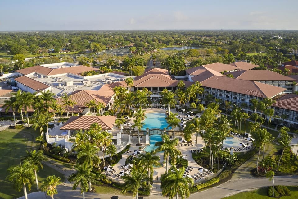 An aerial look at the grounds: five courses, lush fairways, and the heated pool all within walking distance