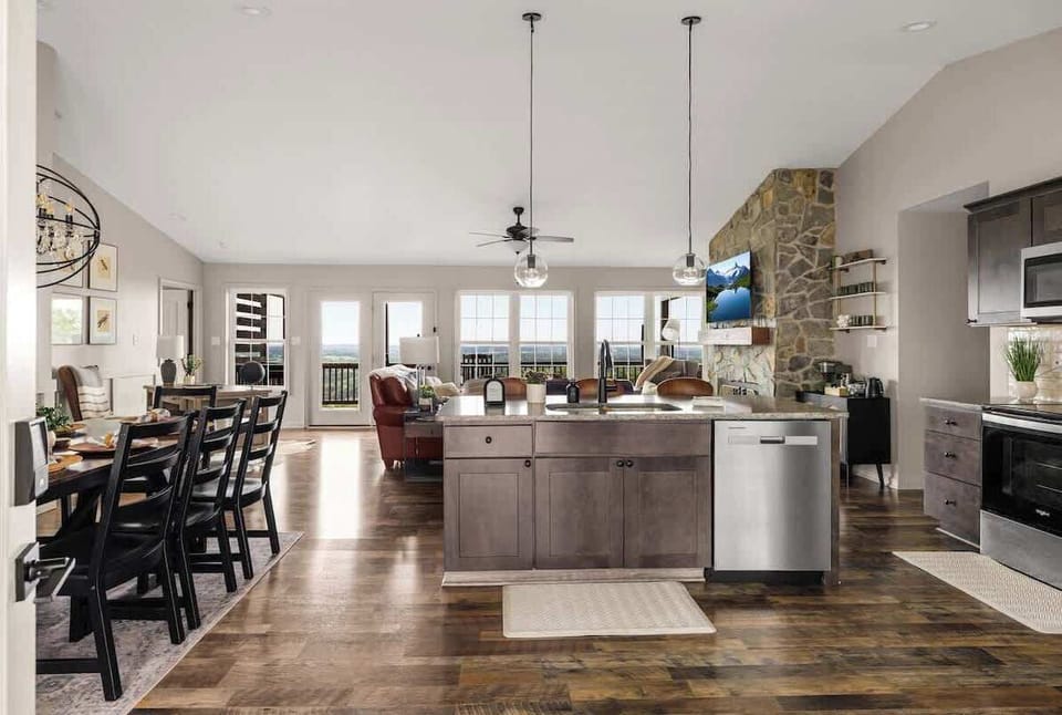 Open kitchen and dining with mountain view through wide windows