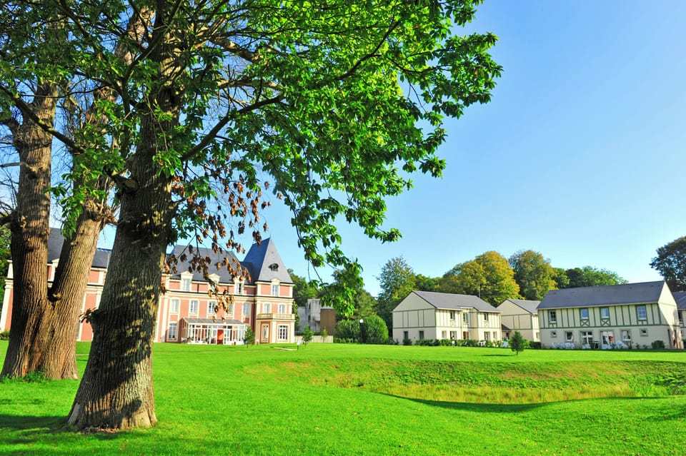 Green lawns and gardens surround the renovated 19th-century château, with your apartment just steps away