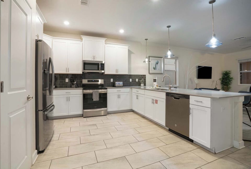 Modern kitchen with stainless steel appliances and a spacious island for family-friendly gatherings.