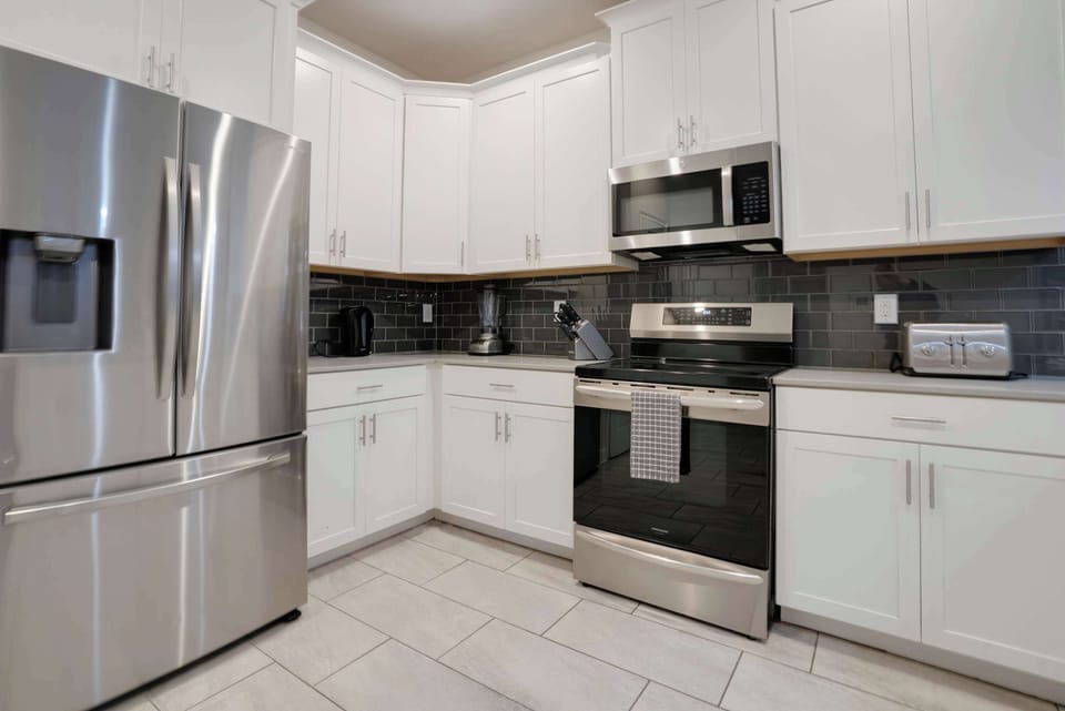 Modern kitchen with stainless steel appliances and white cabinetry
