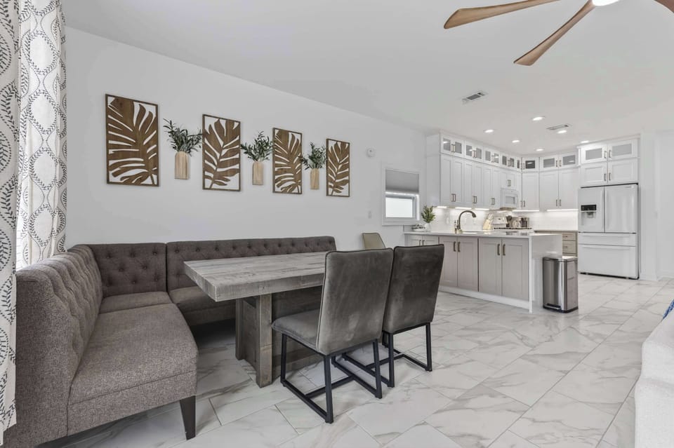 Stylish Multi-Functional Dining

A stylish space maximizing function with a comfortable tufted banquette and rustic wood table. Unique carved wall art creates a sophisticated backdrop that transitions seamlessly to the modern white kitchen.
