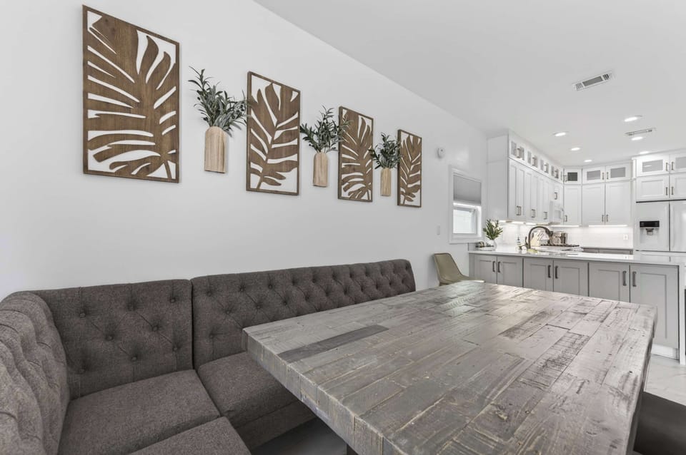 Stylish Multi-Functional Dining

A stylish space maximizing function with a comfortable tufted banquette and rustic wood table. Unique carved wall art creates a sophisticated backdrop that transitions seamlessly to the modern white kitchen.