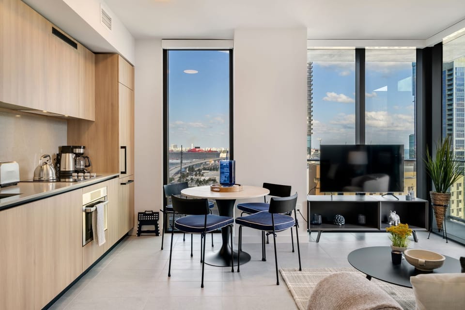 Bright corner living space with floor-to-ceiling windows and beautiful city view