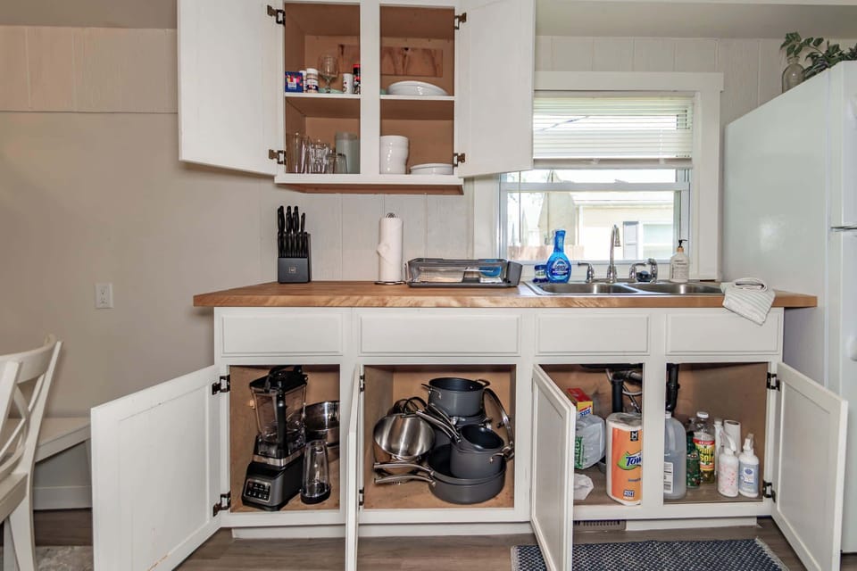 Dedicated coffee station with a Keurig, drip coffee maker, and electric kettle. Enjoy a variety of mugs, teas, and coffee selections in this stylish morning nook.