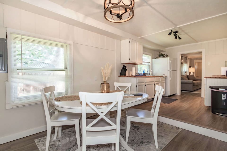 Charming dining area with seating for four and natural light. The open layout connects seamlessly to the kitchen and living room, making it a great spot for morning coffee or dinner.