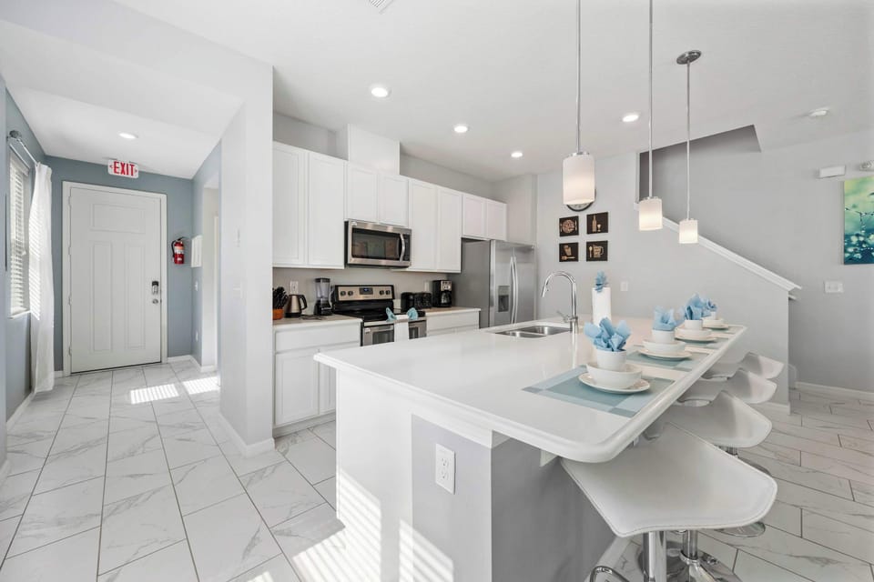 Bright, modern kitchen with stainless appliances, quartz island, and a breakfast bar for 4-perfect for pancakes and planning the day!