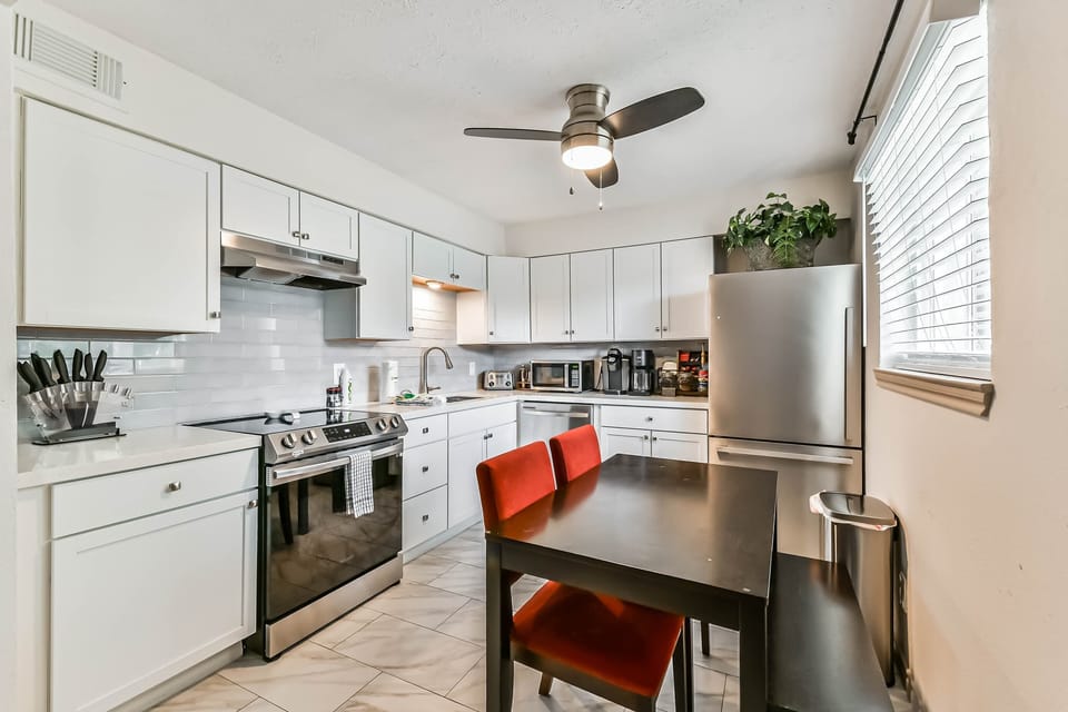 Fully equipped kitchen with stainless steel appliances, sleek quartz counters, and everything you need to cook and dine in comfort.