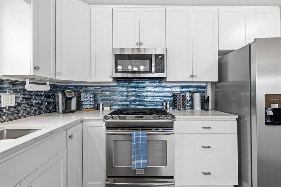 Contemporary kitchen featuring stainless steel appliances and plenty of storage for extended stays.