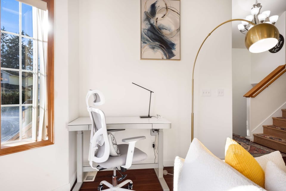 Work from home with ease at this bright desk—natural light, a comfy chair, and a sleek setup for productive days.