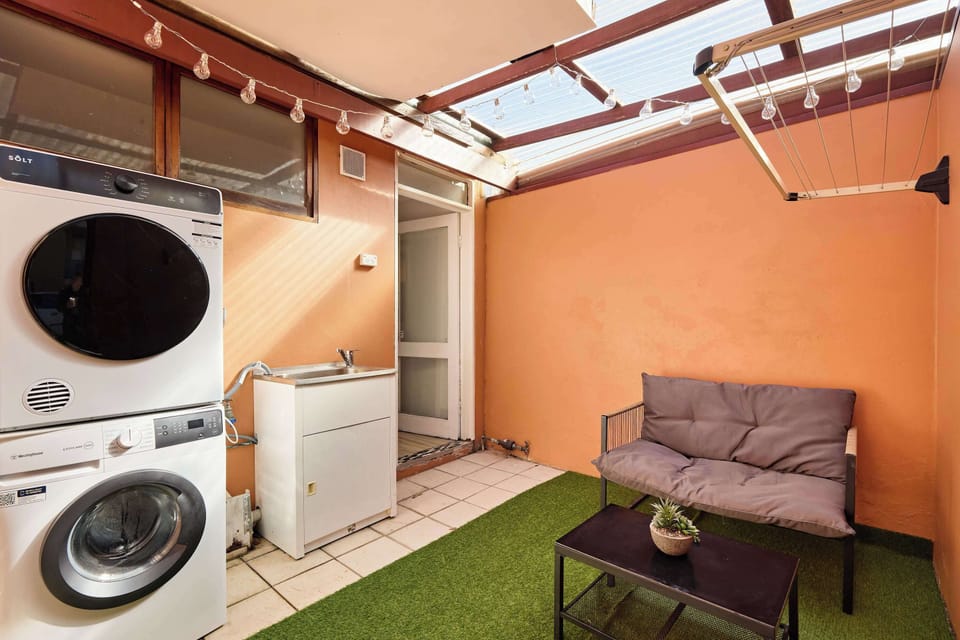 Our covered laundry and utility area offers versatility and practical functionality with added outdoor charm. It features private sheltered layout, built-in laundry facilities, and relaxed seating space.