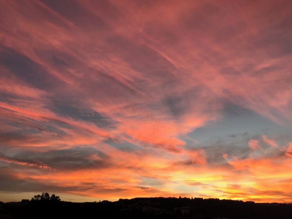 Enjoy beautiful sundowners on your balcony watching a show from nature