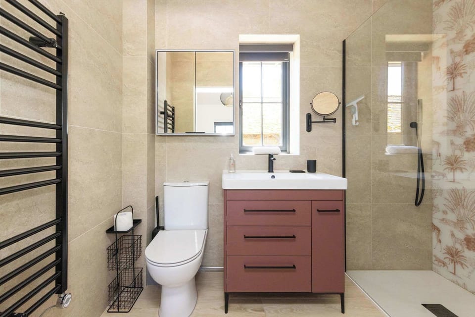 Refresh in a modern bathroom with walk-in shower, earthy tones, and simple Sussex countryside comfort.