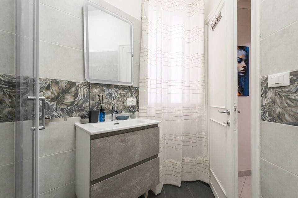Bright modern bathroom with elegant finishes and stylish tropical accents.